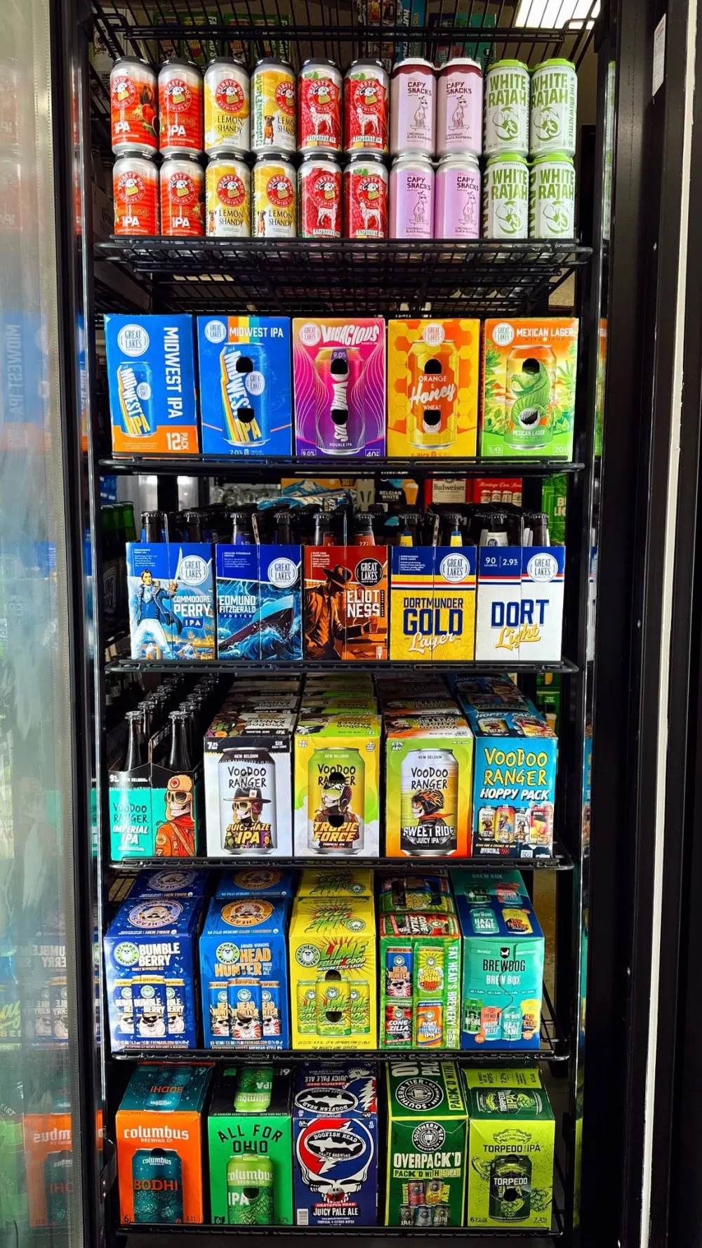 Cooler shelves of Ohio craft beer cans and twelve-packs