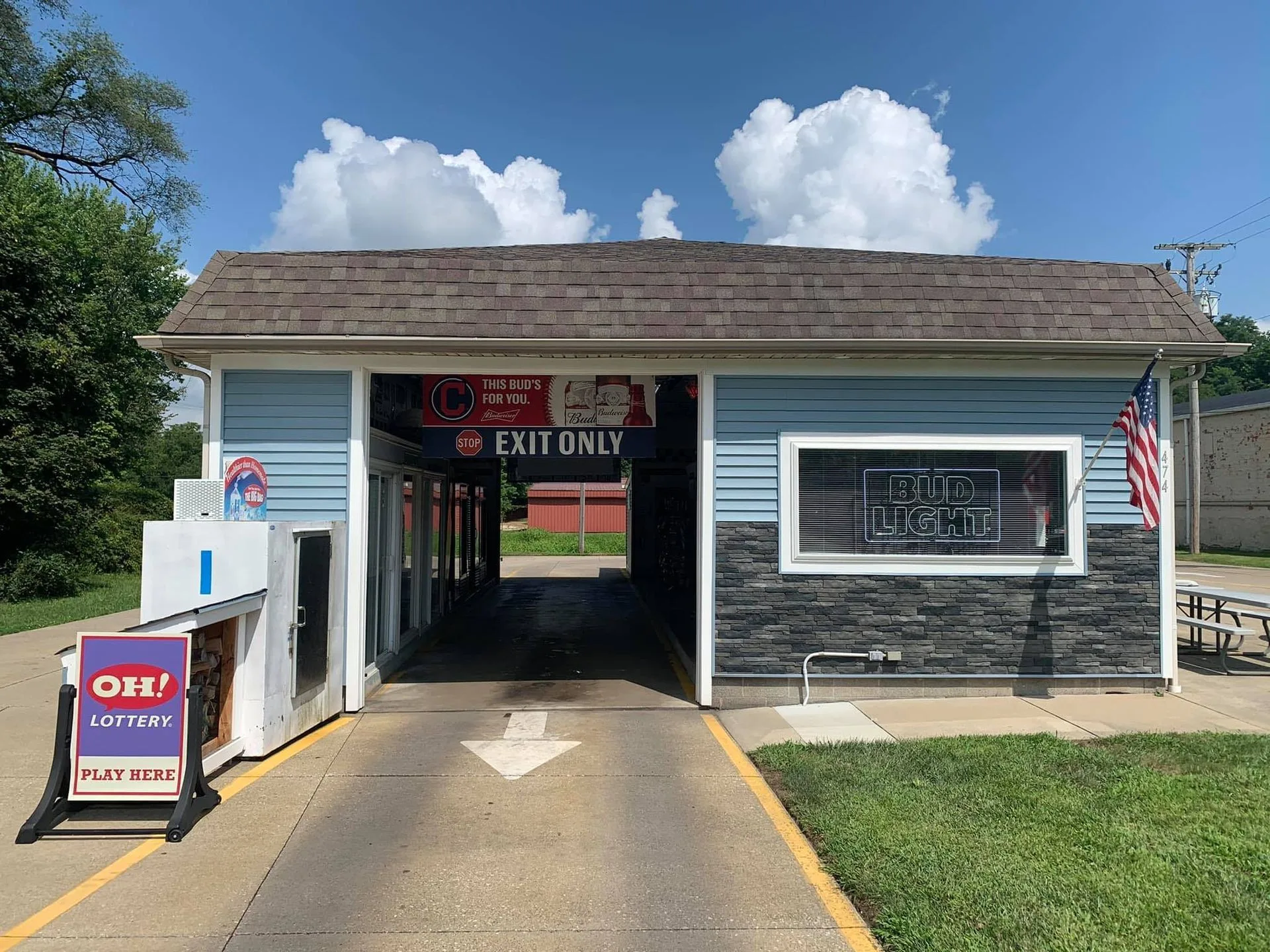 The Bear Cave drive-thru lane running through the light blue building at 474 College St