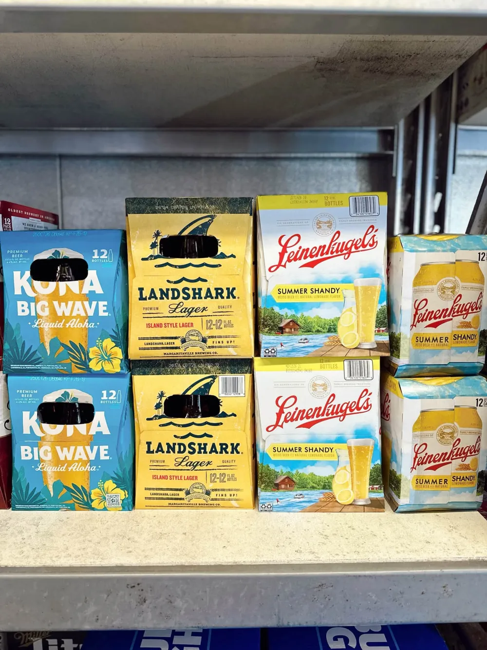 Twelve-packs of summer lagers and shandies stacked on a shelf